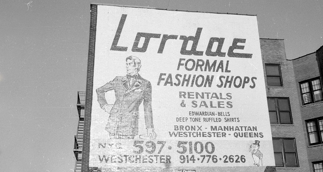 Historical photo of Lordae advertising, 3-stories high on brick building